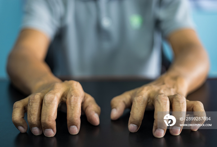 Close-up front view of both hands of a thai man wearing gray shirt making various gestures.