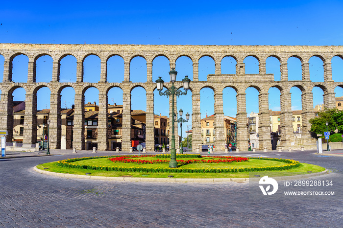 Roman aqueduct of Segovia with circular square in front of the Unesco monument, Spain.