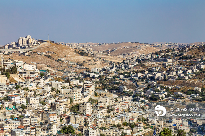 Small village and the Israeli West Bank barrier or wall - separation barrier on the West Bank in Israel. View from Montefiore Windmill