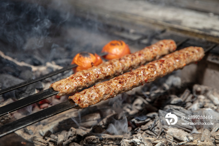 Kebab or kebap on metal skewer barbecue in the kebap restaurant. Traditional Turkish Adana Kebab