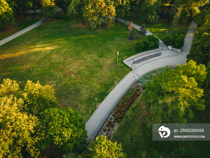 City park from above, summer evening at city park, Pedestrian paths and crosswalks in city park. Green area in the city