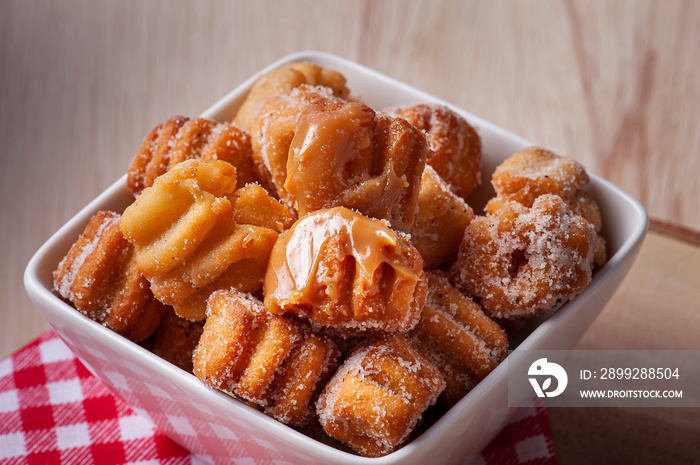 .Homemade mini churros with dulce de leche