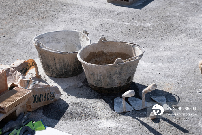 Various masonry and brickwork tools being used on a construction site