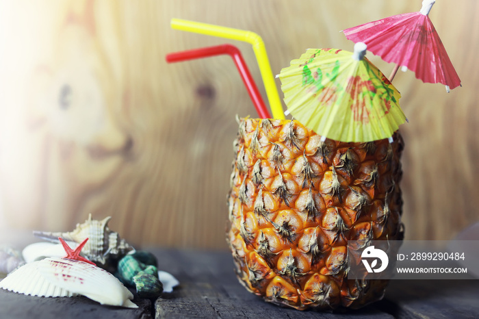 pineapple with straw and cocktail umbrella