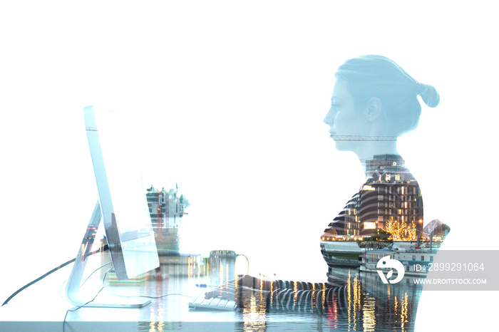 Silhouette of businesswoman working with her laptop and city on background. Trade and network concept.