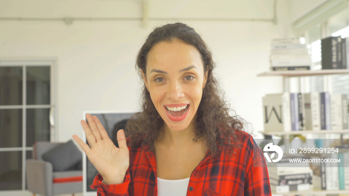 Portrait of happy smiling business, latin woman, people talking on webcam video meeting, call conference, working online in quarantine on bed in bedroom at home. Lifestyle. Looking at camera. Webinar