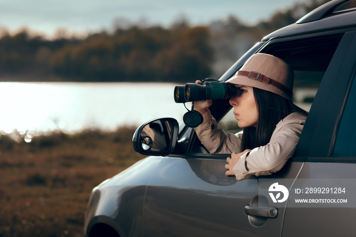 Female Detective Spying with Binocular from a Car