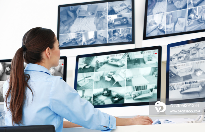 Beautiful security guard in surveillance room