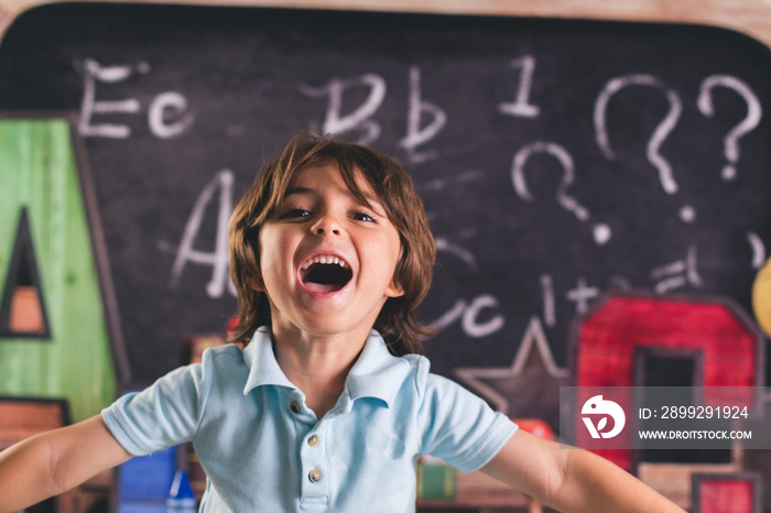 back to school kid pre k child in front of board chalk chalkboard a b c