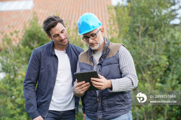 Builder going through outdoor plans with homeowner