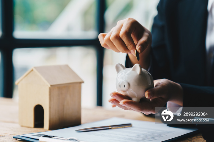 Woman hand putting coins in piggy bank for account save money. saving money for future plan, retirement fund. Business investment finance accounting concept.