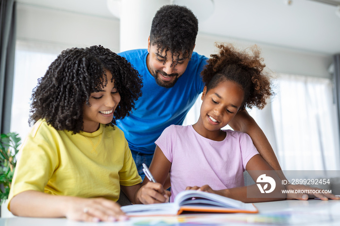 Front view of African American parents helping their daughter with homework at table, Photo of a young girl being homeschooled by her parents