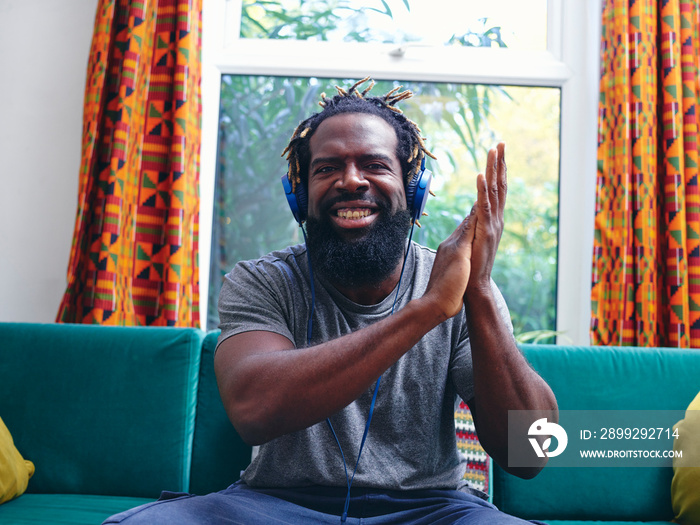 Portrait of man listening to music on headphones