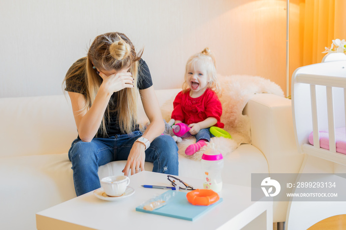 Exhausted mother with little child