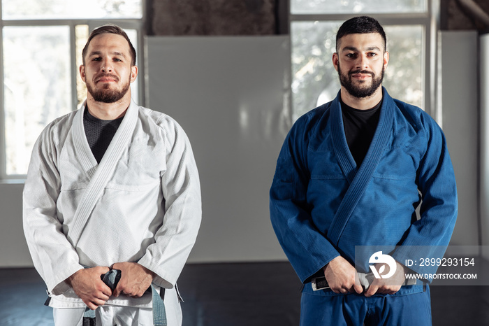 Two men in kimonos holding on to their belts