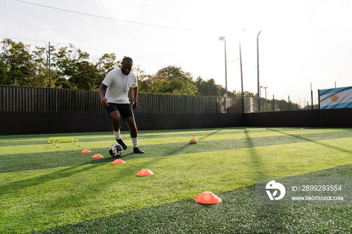 Soccer player practicing on soccer field