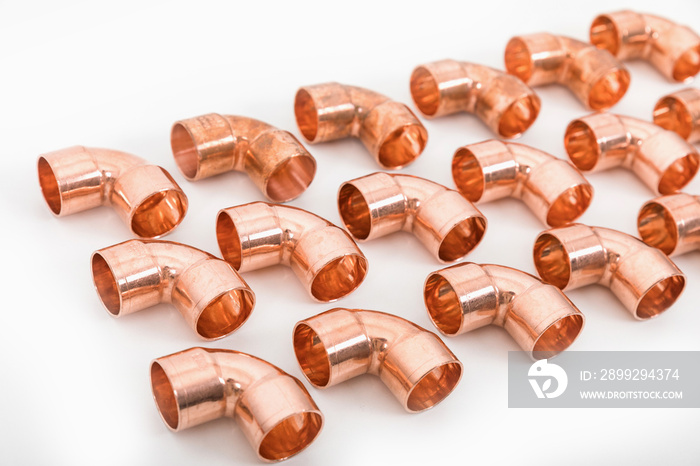 Group of fittings on a white background. Copper fittings for pipe connections. Technical basis for heating companies.