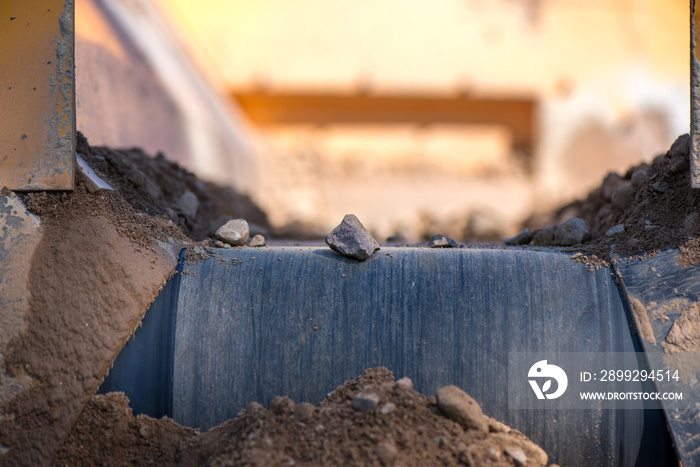 Rock filtering conveyor belt at a quarry. Pebbles and gravel falling out of a filtering facility onto a conveyor belt