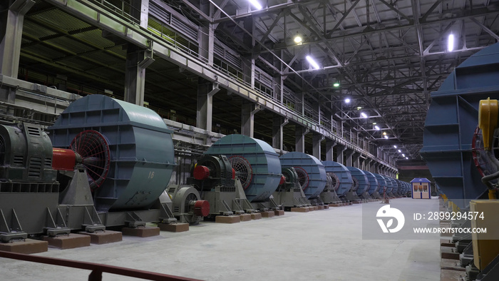 Copper crushing plant. Ball mills in large room of shop at mining enterprise. Crushing equipment at large mining plants