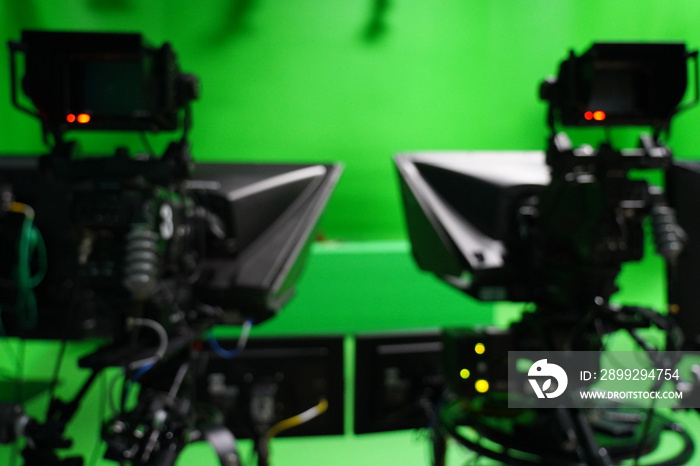 abstract blurred of broadcast camera in studio with virtual greenscreen at TV station.