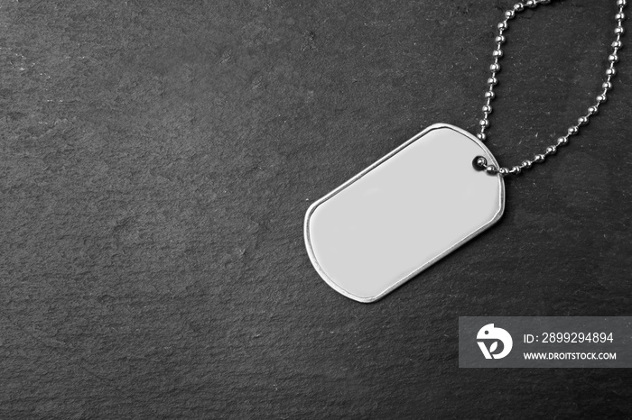 Military ID tag on dark background