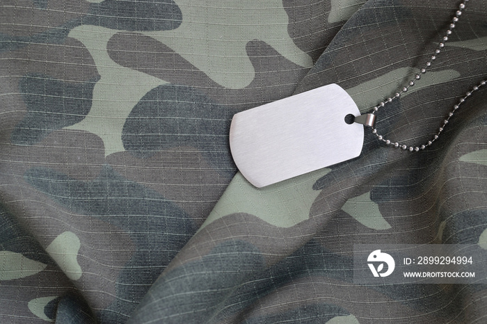 Silvery military beads with dog tag on camouflage fatigue uniform