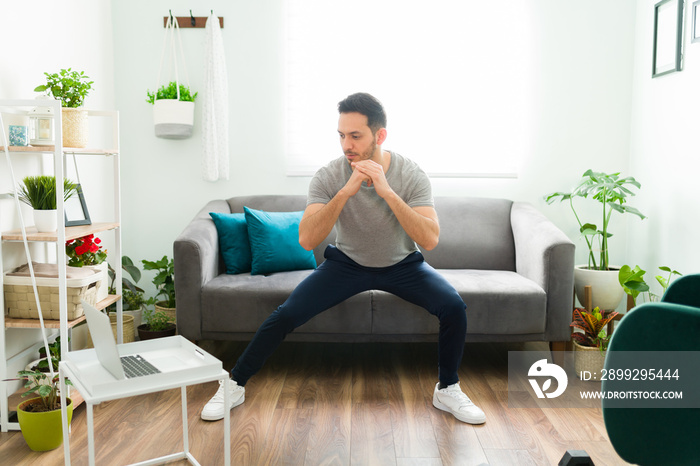 Adult man with a healthy lifestyle exercising at home