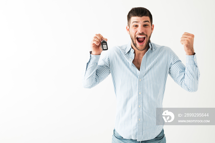 Young man just received the keys of his brand new car