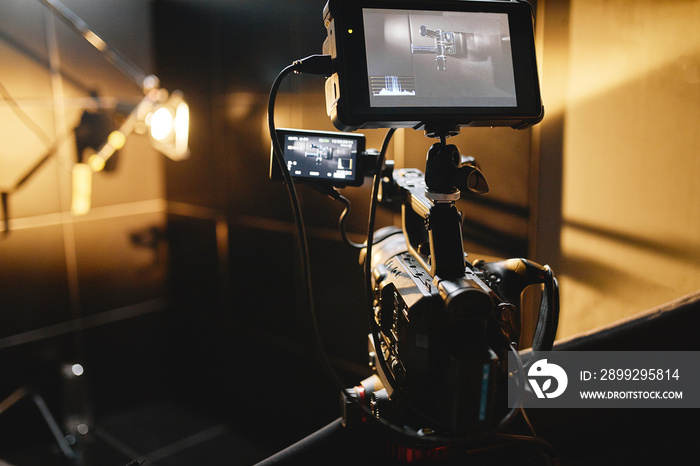 Video production backstage. Behind the scenes of creating video content, a professional team of cameramen with a director filming commercial ads. Video content creation, video creation industry. Low