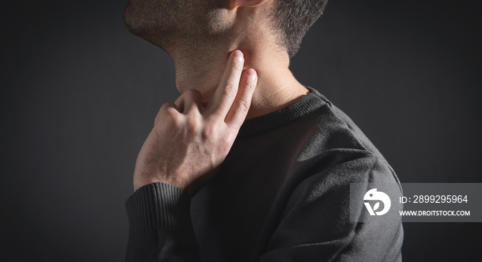 Caucasian man checking pulse at home.