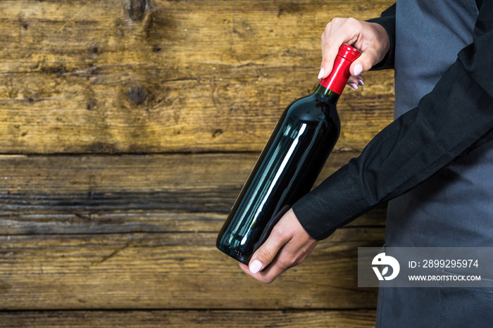 waitress showing red wine bottle