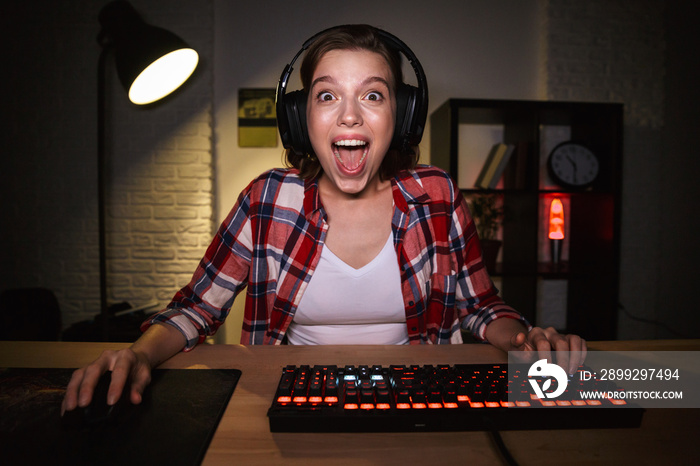 Portrait of an excited young woman wearing headphones