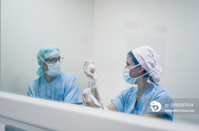 Doctors washing hands before operation