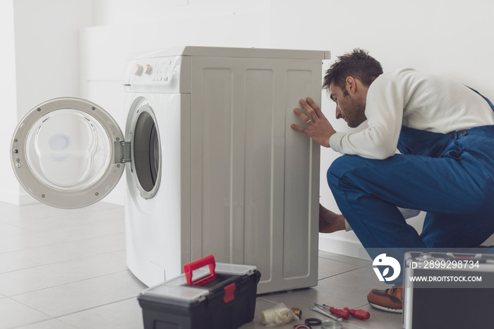 Professional repairman fixing a washing machine