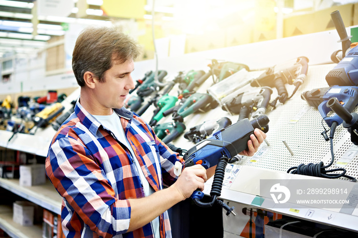 Man shopping for perforator in hardware store