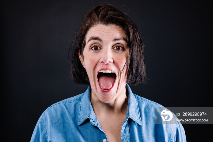 portrait of a woman surprised with her mouth wide open