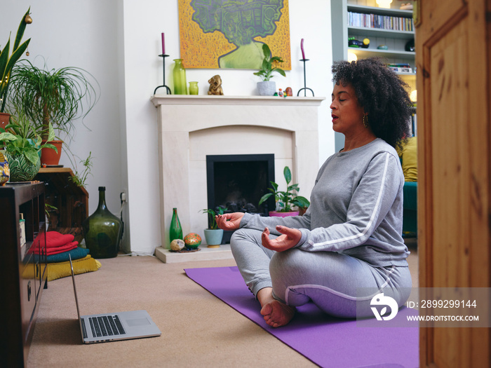 Woman practicing yoga at home