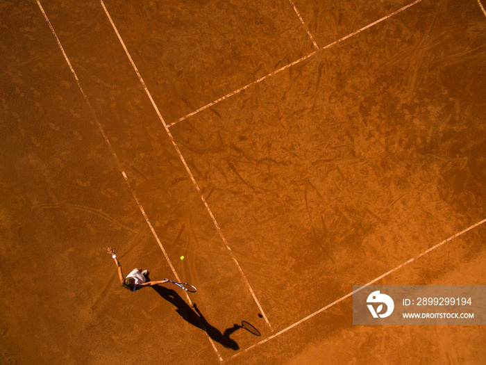 Female tennis player on the court. Wide angle view from above with plenty of copyspace