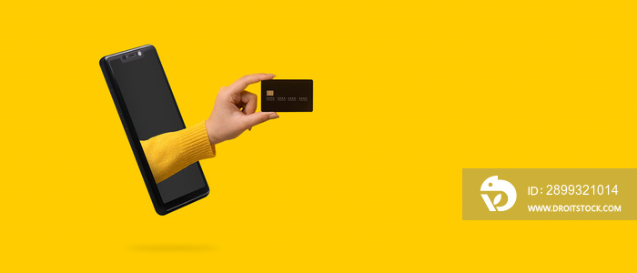 bank card in hand sticking out of the smartphone screen, panoramic image