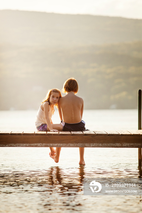 Friends sitting on pier