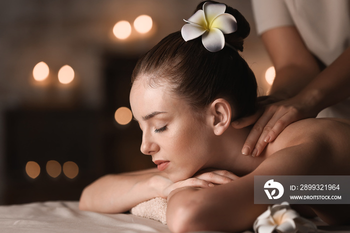 Young woman having massage in spa salon