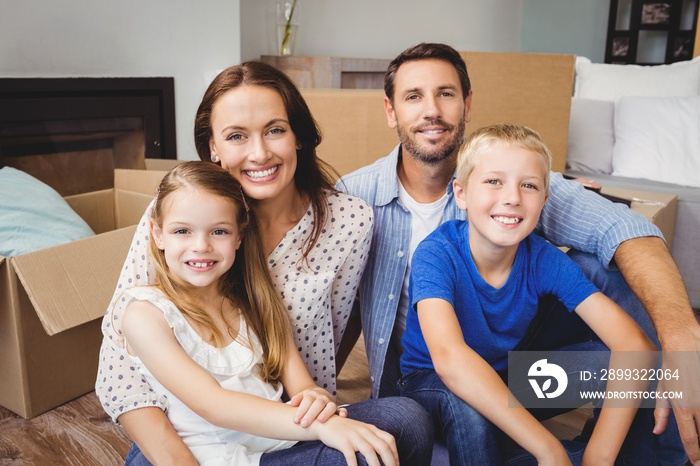 Portrait of smiling family with cardboard boxes