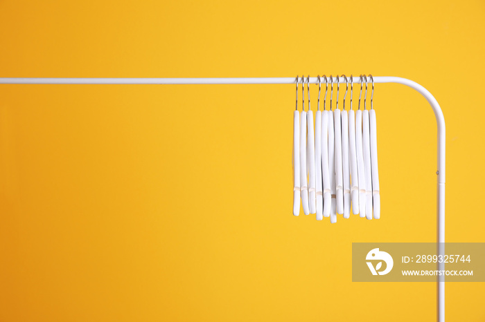 Modern hangers on yellow wall background