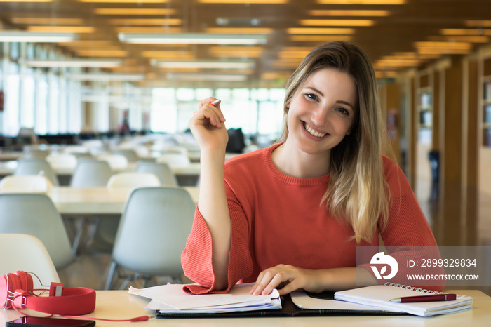 Young female student studying in the library.