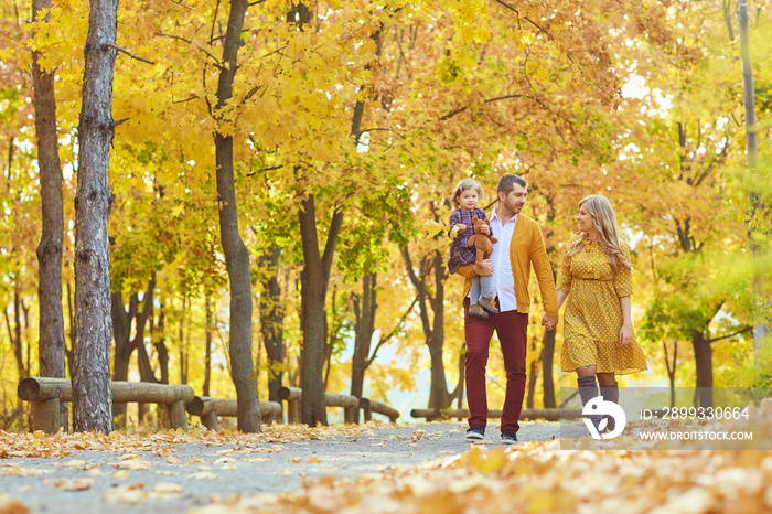 黄色秋天，一家人在公园里散步。