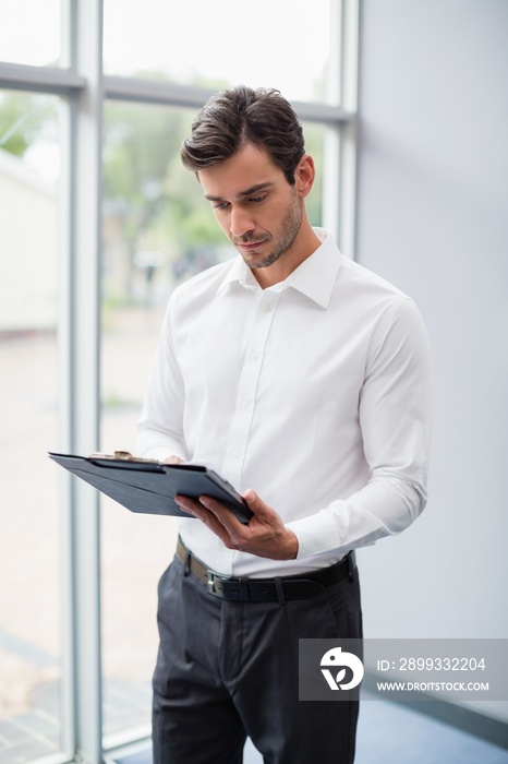 Businessman looking at clipboard