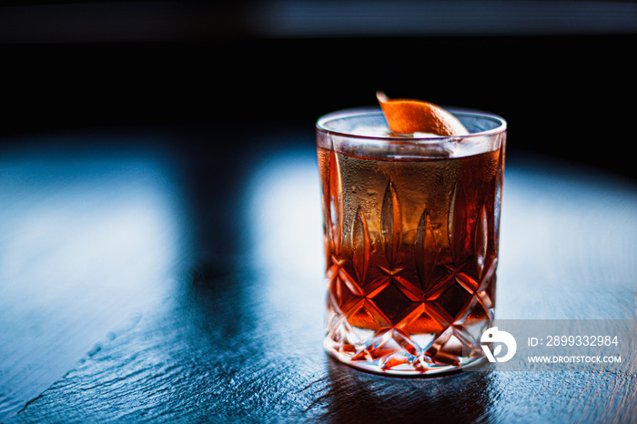 Negroni cocktail on dark stone table. With space for your text