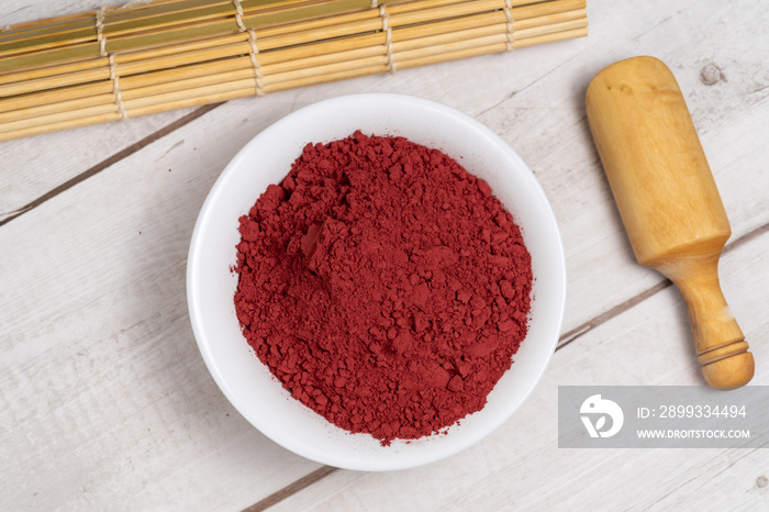 Red yeast rice powder or angkak. Chinese natural coloring and spice for cooking and food.