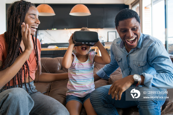 Family playing video games with VR glasses.