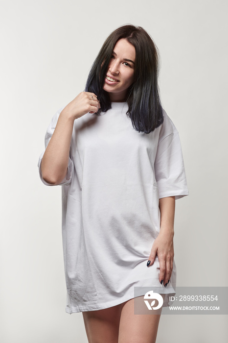 beautiful smiling young woman in white oversize t-shirt with copy space looking at camera isolated o